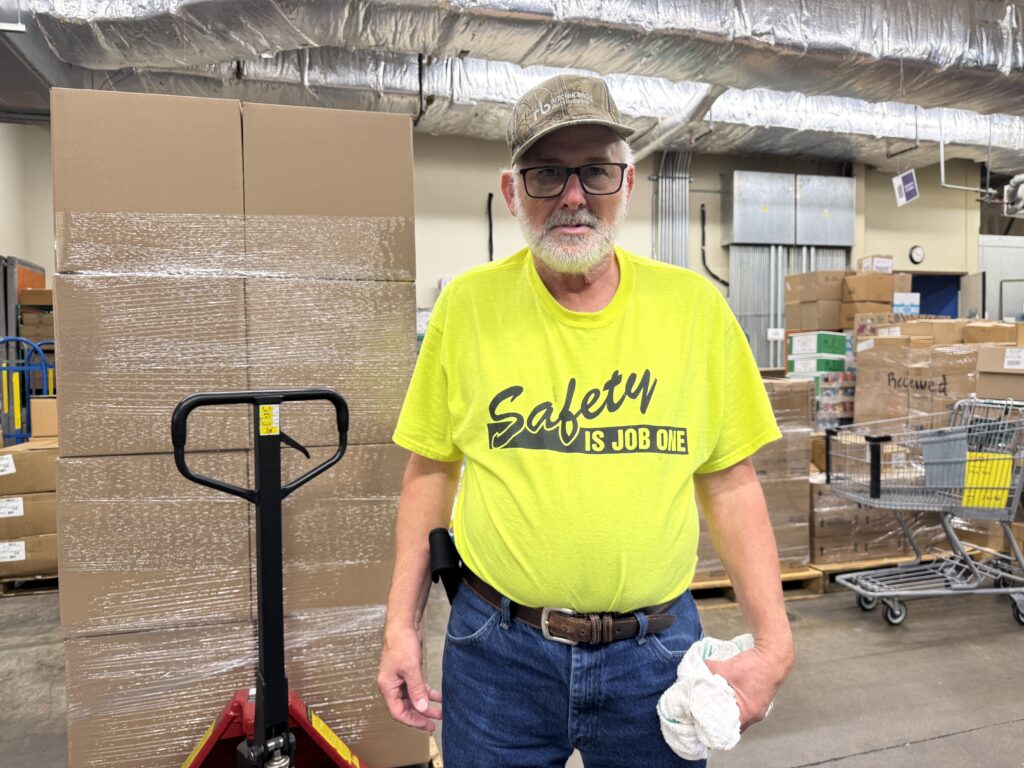 Man stands in warehouse in front of boxes